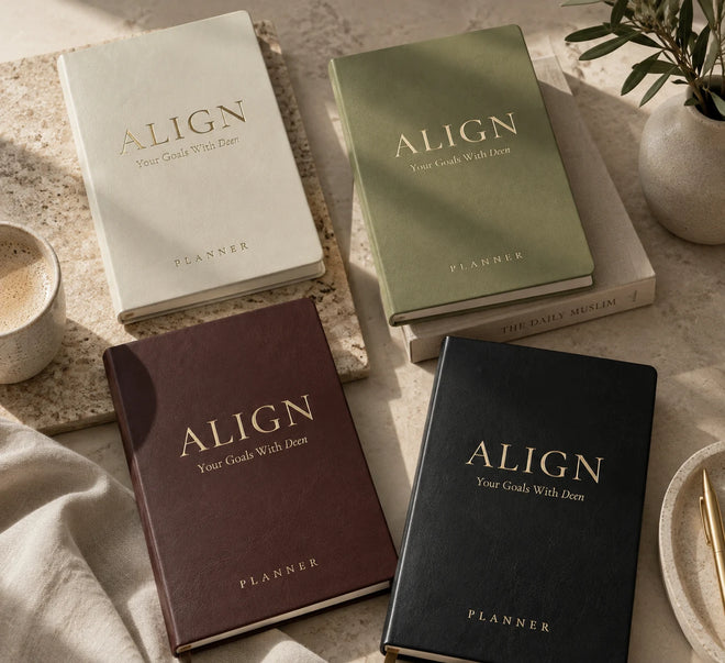 Four Align planners in ivory, sage, chocolate and ebony on a warm stone surface